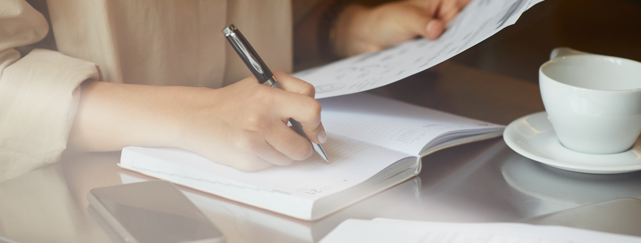 Woman writing down goals to avoid holiday weight gain Woman writing down goals to avoid holiday weight gain